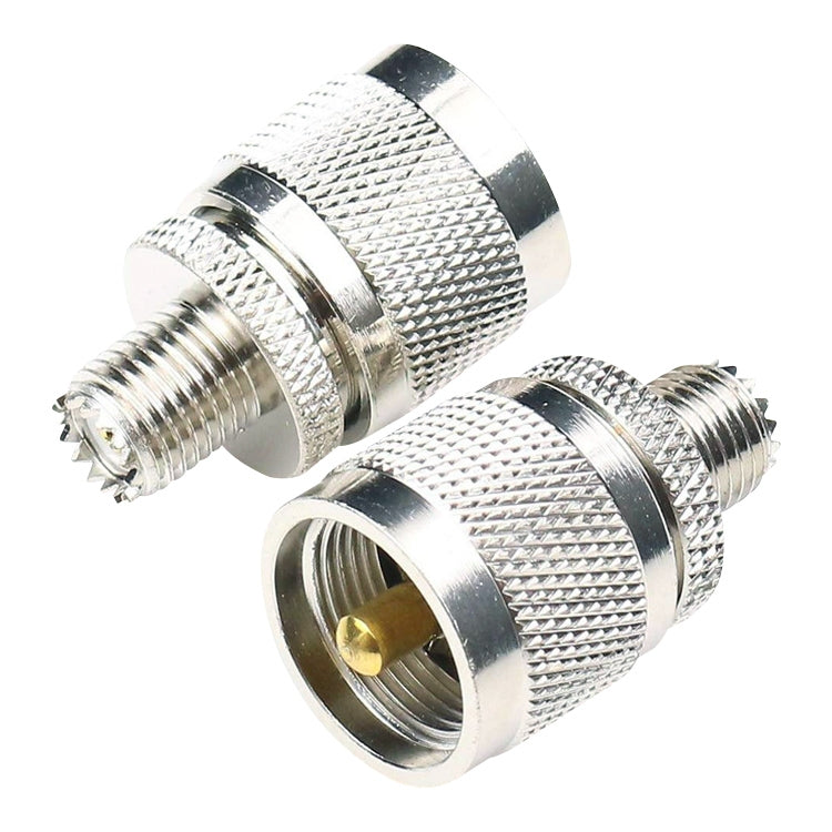 RF coaxial adapter showing two ends: male threads and female threaded socket