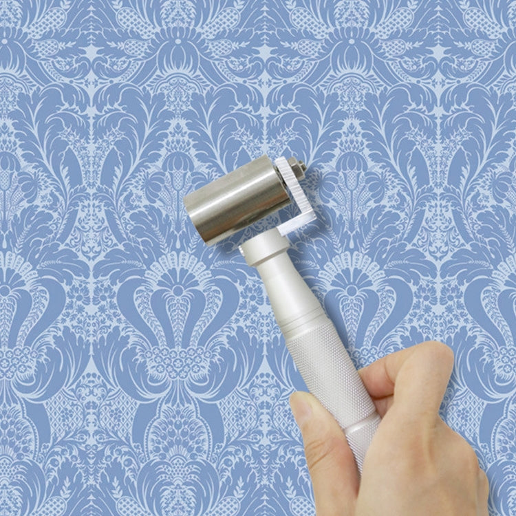Wallpaper seam roller tool held in hand for smoothing wall seams