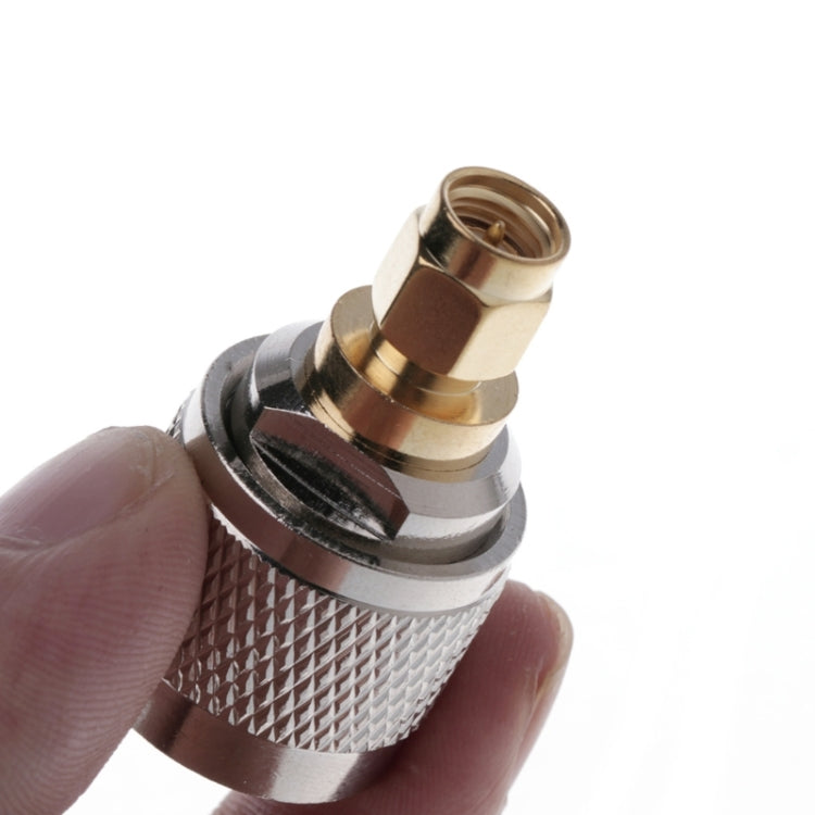 RF adapter close-up: silver knurled grip, brass ring, internal threaded SMA port