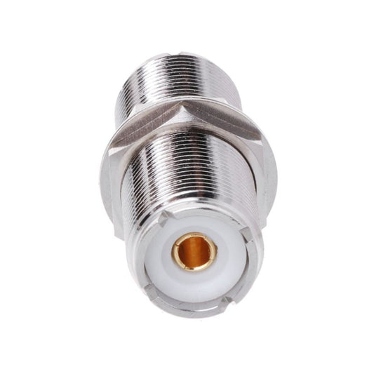 UHF female-to-female connector adapter, front view of gold center contact in white insert