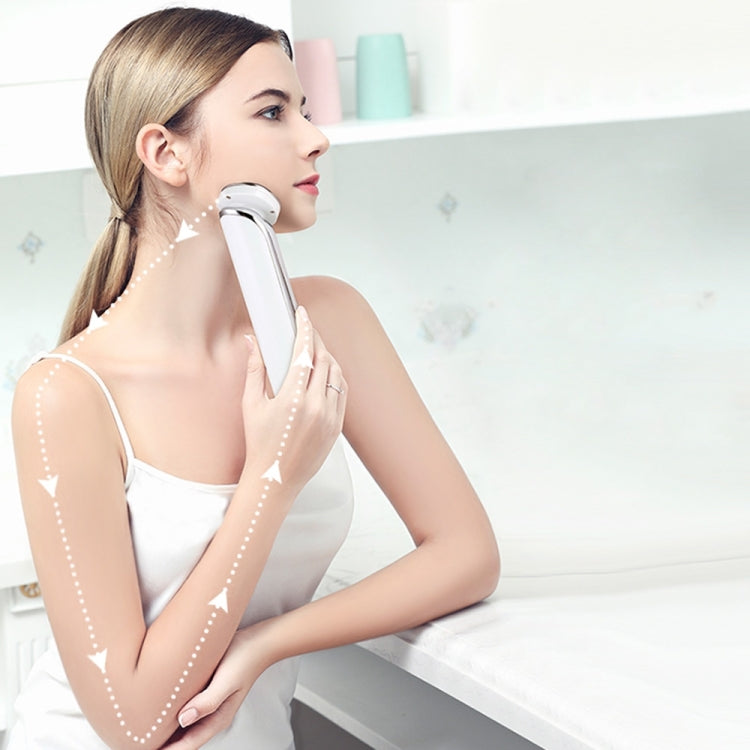 Woman using a white ion face cleansing massager on her cheek for deep cleaning.