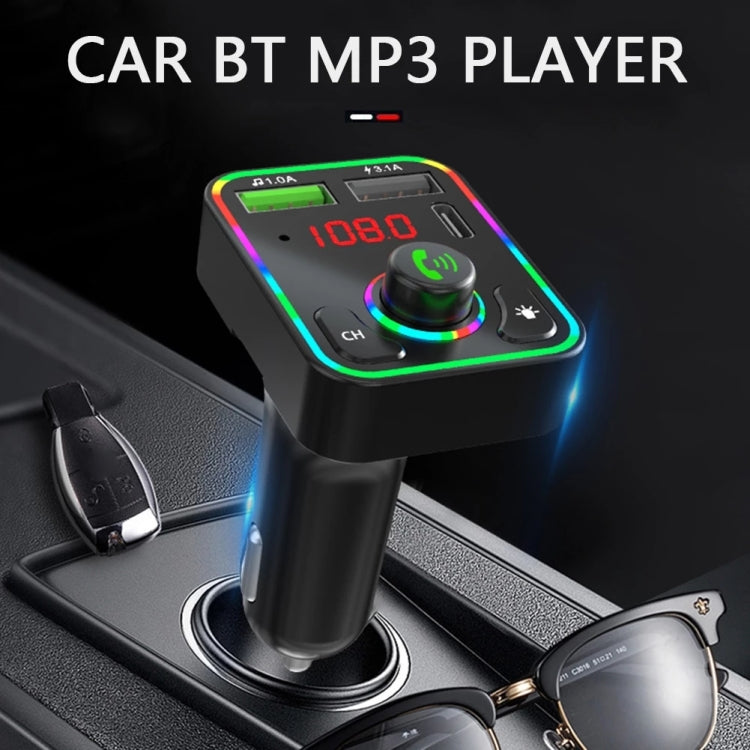 Black car FM transmitter/charger with LED frequency display plugged into a car port