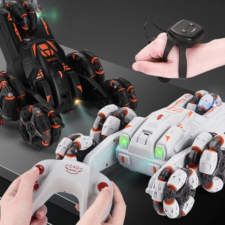 White and black RC stunt cars with remote controller, hands holding the gamepad