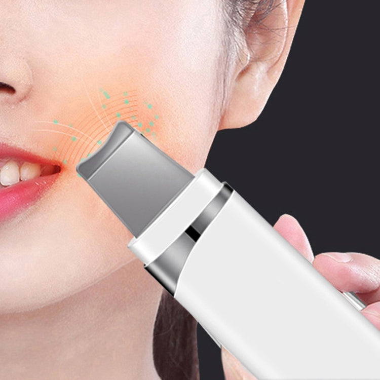 White ultrasonic pore cleaner device held against the cheek for facial cleaning