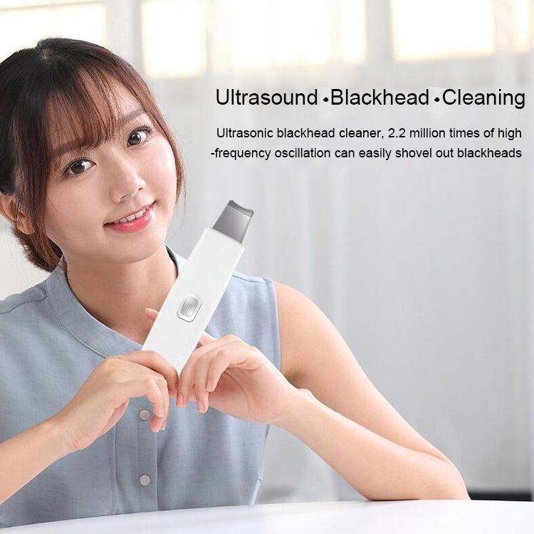 White handheld ultrasonic facial scrubber with metal tip and control button