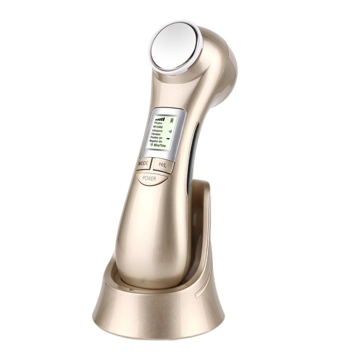 Gold-toned facial skin care device on stand with round faceplate