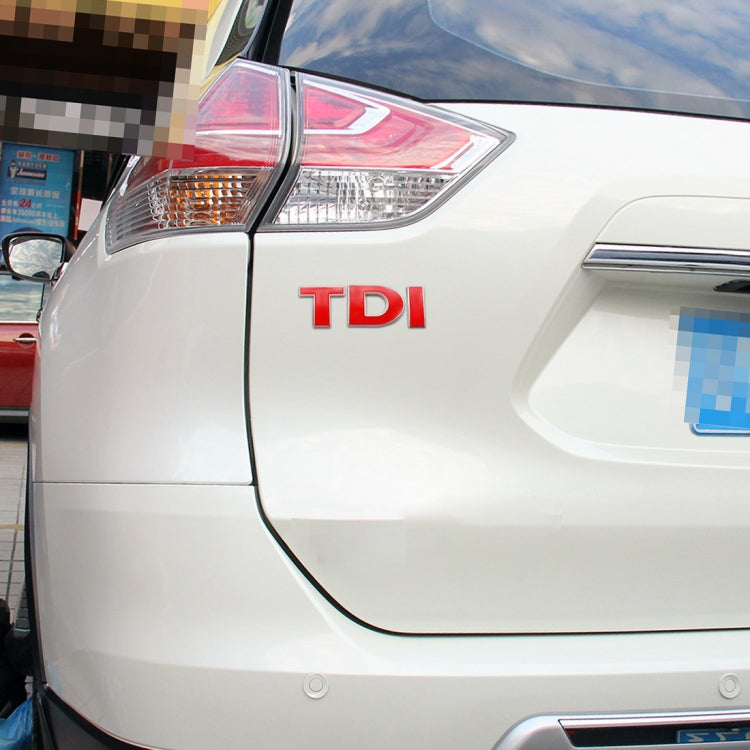 Red TDI letters 3D chrome badge decal sticker on white car door panel