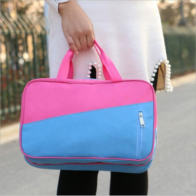 Pink and blue travel duffel bag with wet-dry separation, zippered front pocket