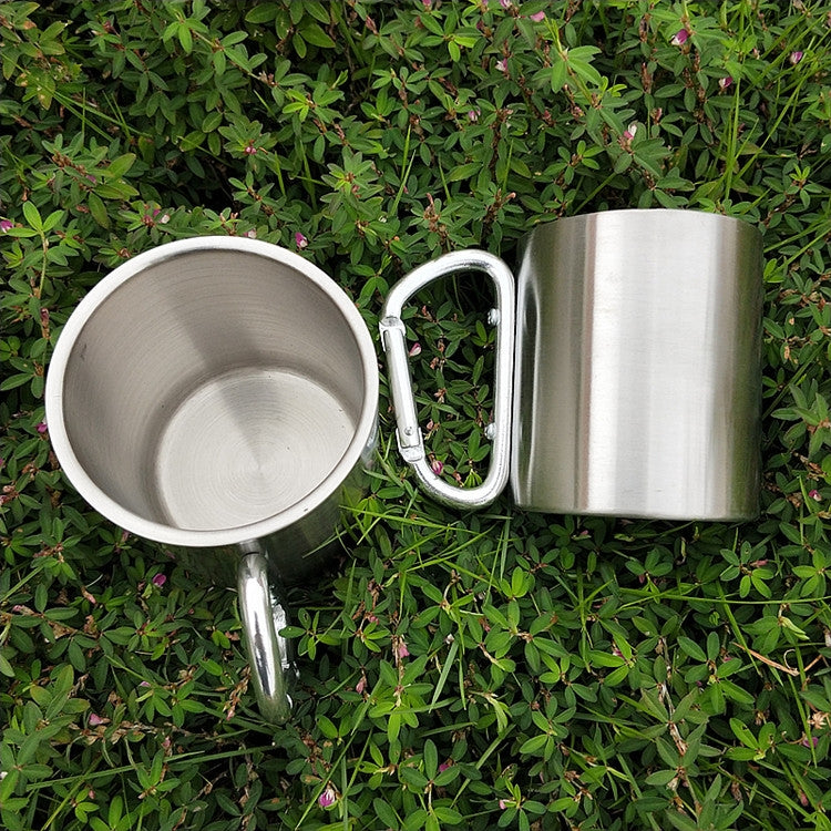 Stainless steel double-walled mug with white carabiner handle, standing and open view