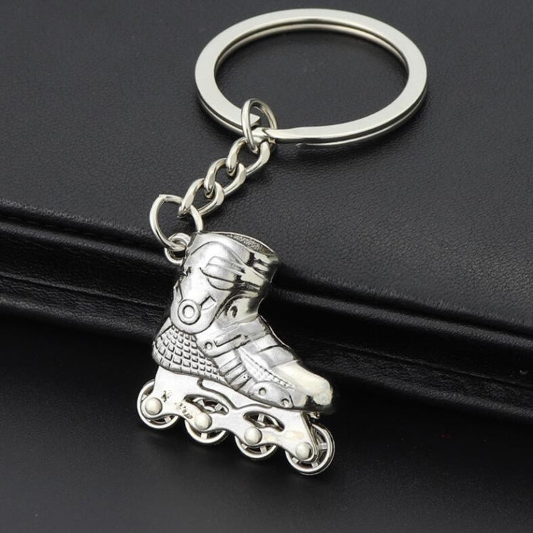 Metallic silver roller skate charm keychain with silver key ring and chain.
