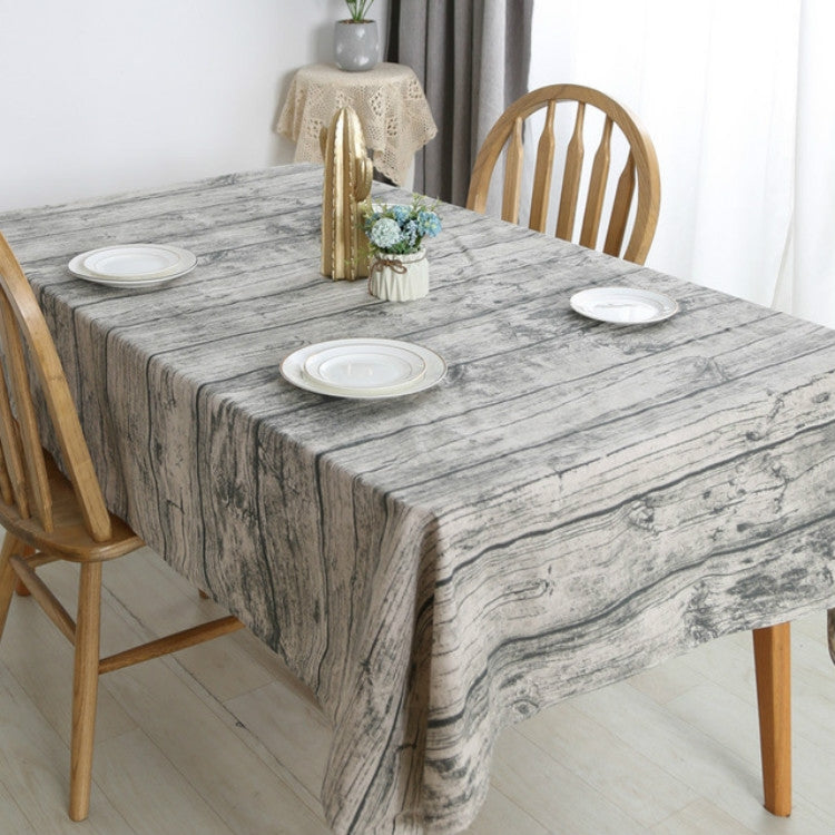 Rectangular linen tablecloth with gray-and-white woodgrain pattern, shown on dining table