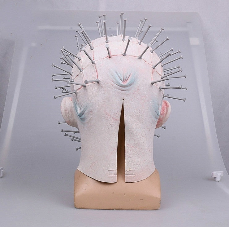 Spiked horror clown mask, pale fabric with blue face detail, back view on display stand