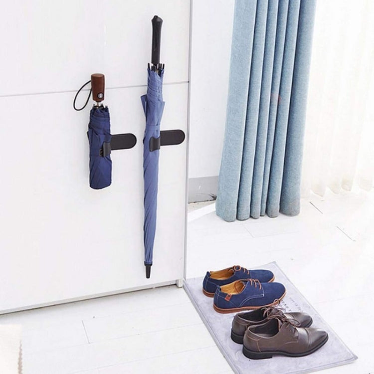 Umbrella hook holder wall mount with black clamp holding umbrellas