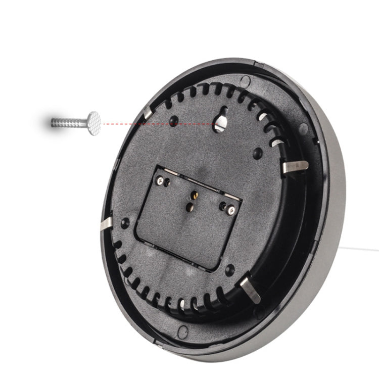 Back of weather station barometer with open black cover, screw holes, and battery space
