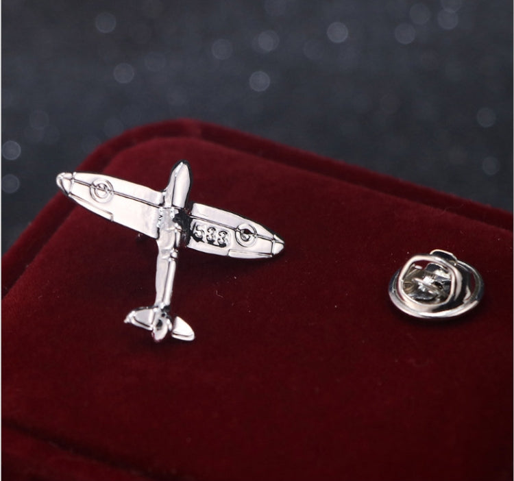 Silver retro airplane brooch pin with round backing on velvet