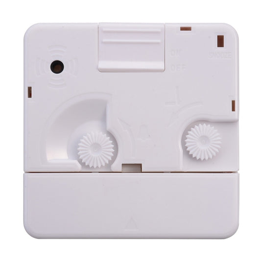 White alarm clock back with settings dials and toggle switches