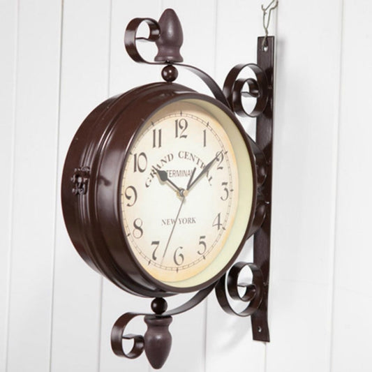 Dark bronze double-sided wall clock with cream face and arched metal bracket mount