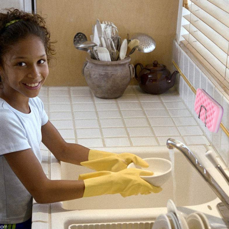 Stainless steel sponge drain rack holding a pink sponge on the sink during cleaning