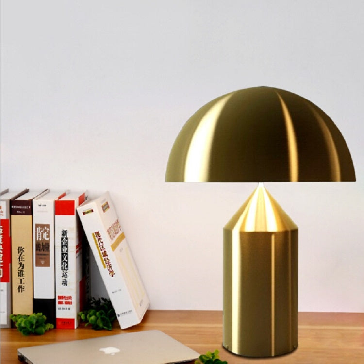 Front view gold dome mushroom table lamp with glowing inner shade