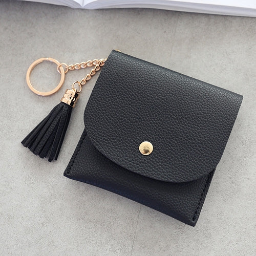 Black mini leather wallet with tassel keychain and snap button front.