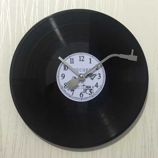 Vinyl record wall clock with black record, white dial, and silver hour and minute hands