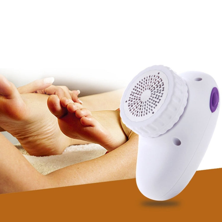 Foot grinder in use on a person’s bare foot; white device with purple button