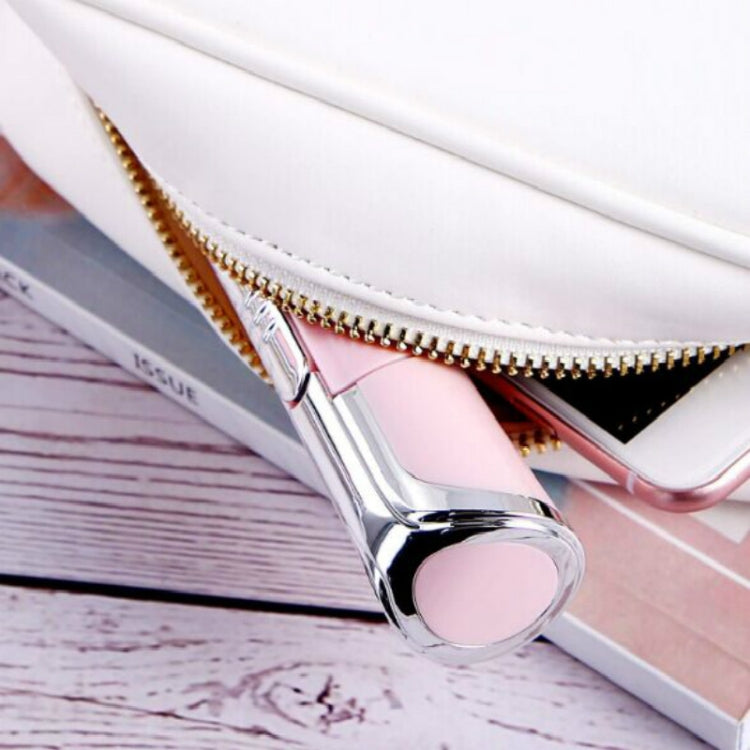Close-up of electric hair removal device head on pink surface and zipper case