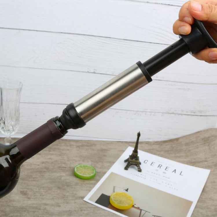 Wine vacuum pump held by hand, with stainless tube and black stoppered end