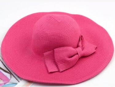 Girls wide-brim straw sun hat with tied fabric bow, bright pink.