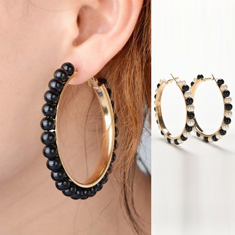 Girls hoop pearl earrings with gold oval hoop and black beaded fringe on ear