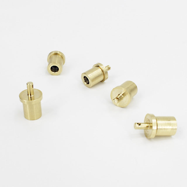 Set of brass gas valve components with black seal and outlet plugs
