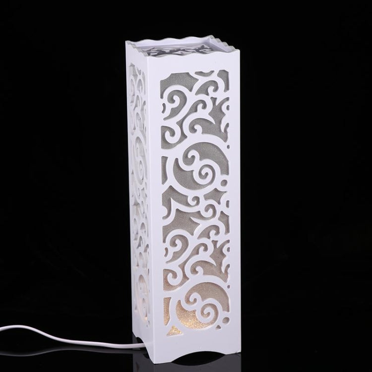 White LED night light with tall carved panel and warm glow from inside