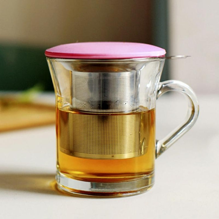 Stainless steel tea infuser strainer in mug with amber tea and red lid
