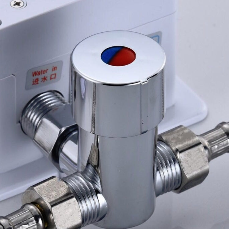 Chrome three-way valve close-up with red/blue indicator window and threaded ports