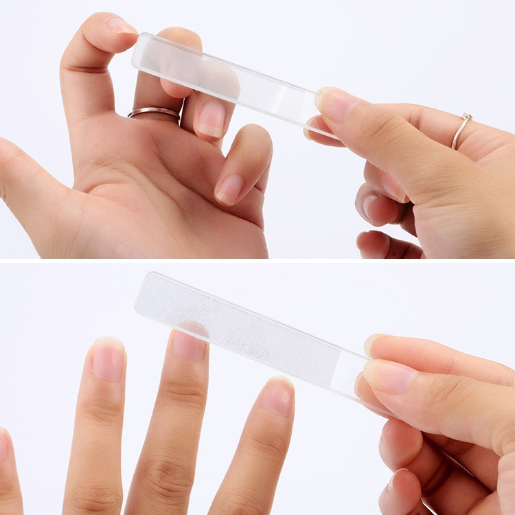 Glass nail file with protective clear cover, close-up between fingers