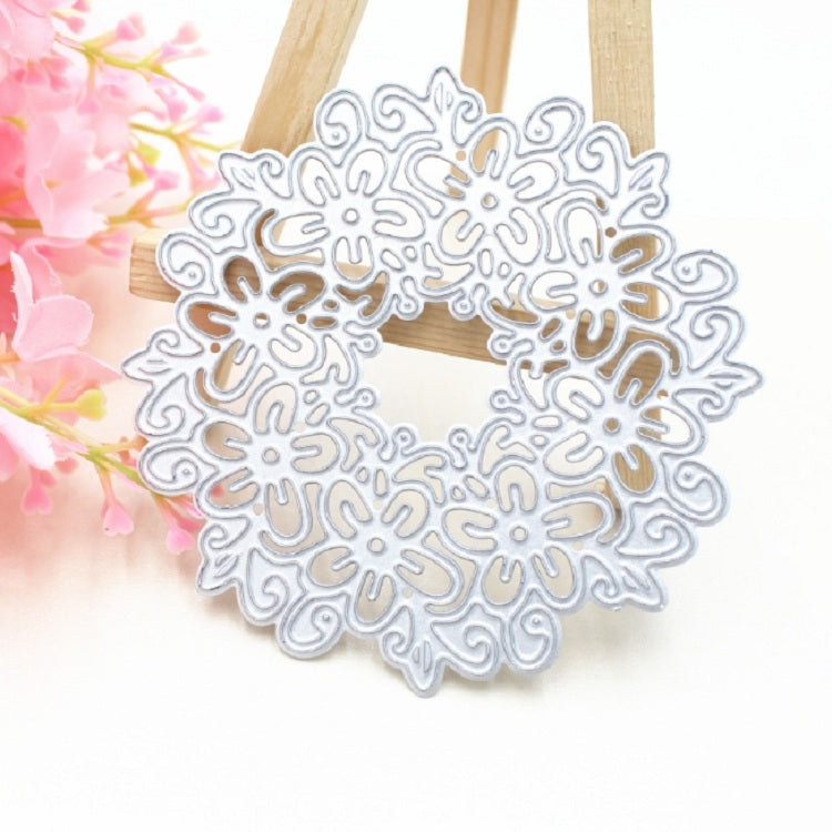 Light blue floral garland die cut wreath with hollow lace pattern on wooden stand