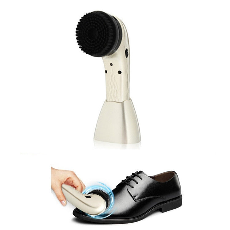 Light-colored handheld shoe cleaner with rotating brush polishing a dark leather shoe