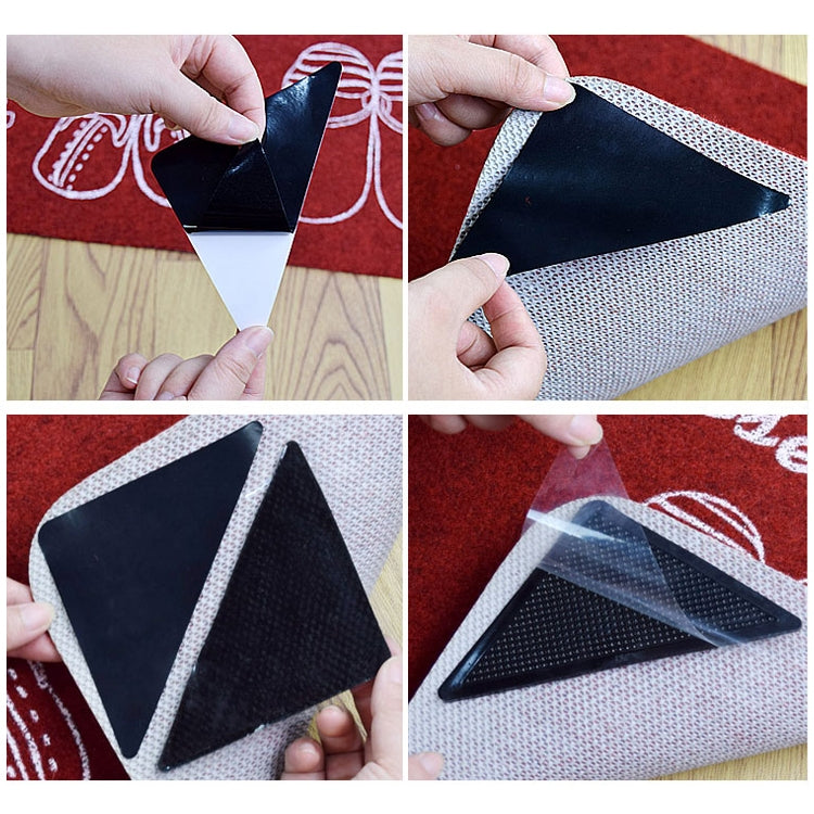 Triangular black non-slip stickers being applied and pressed onto floor surface.