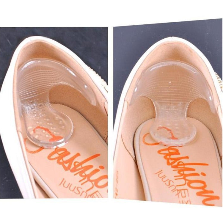 Two clear T-shaped insole stickers installed in high-heel shoes, arch support visible