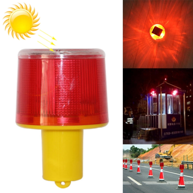 Red warning flash beacon light with yellow base, front close-up with glowing inset