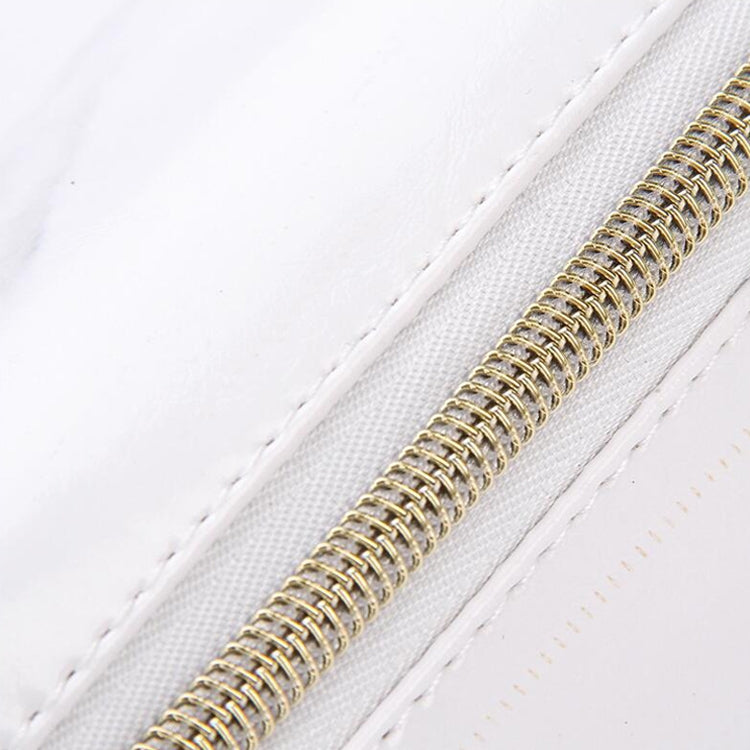 Gold metal zipper on white marble PU pencil case, close-up