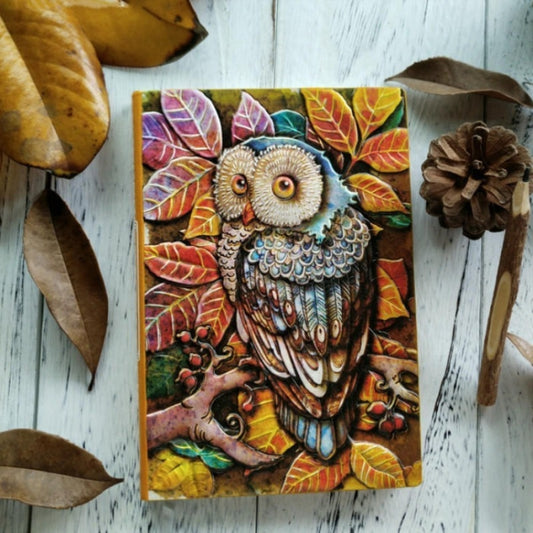 Owl sketchbook journal with colorful embossed cover and decorative leaf border.