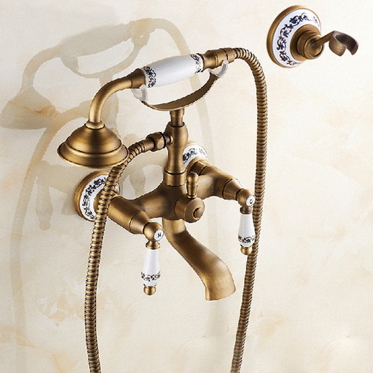 Antique brass wall-mounted tub faucet with dual handles and hand shower hose
