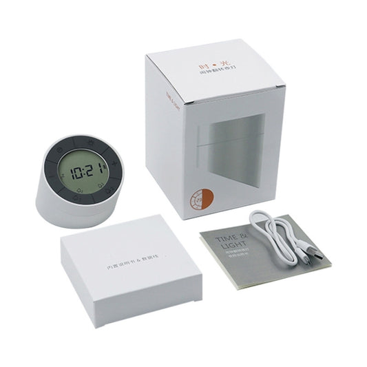 White alarm clock night light, remote package set, power cable, and instruction booklet.