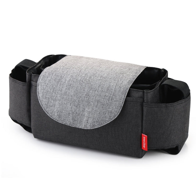 Dark gray baby diaper bag with light gray front flap and side pockets, red label