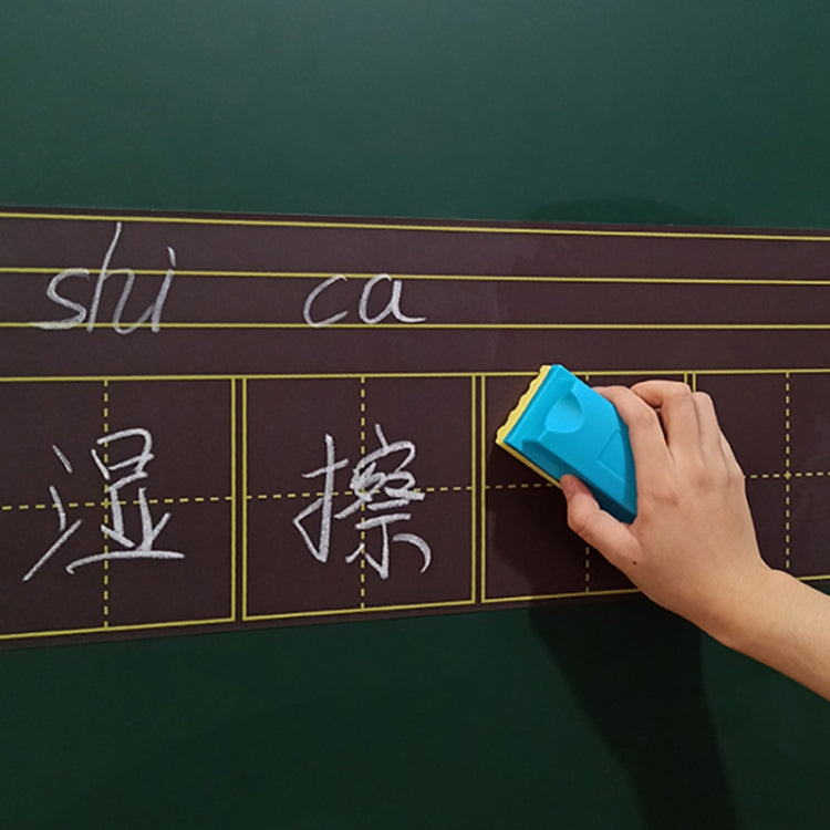 Hand holding blue sponge board eraser over chalk writing on board