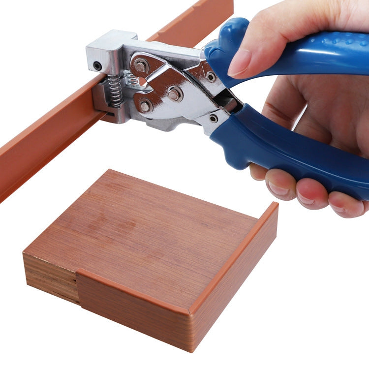 Edge banding pliers clamping an orange strip onto a wood corner