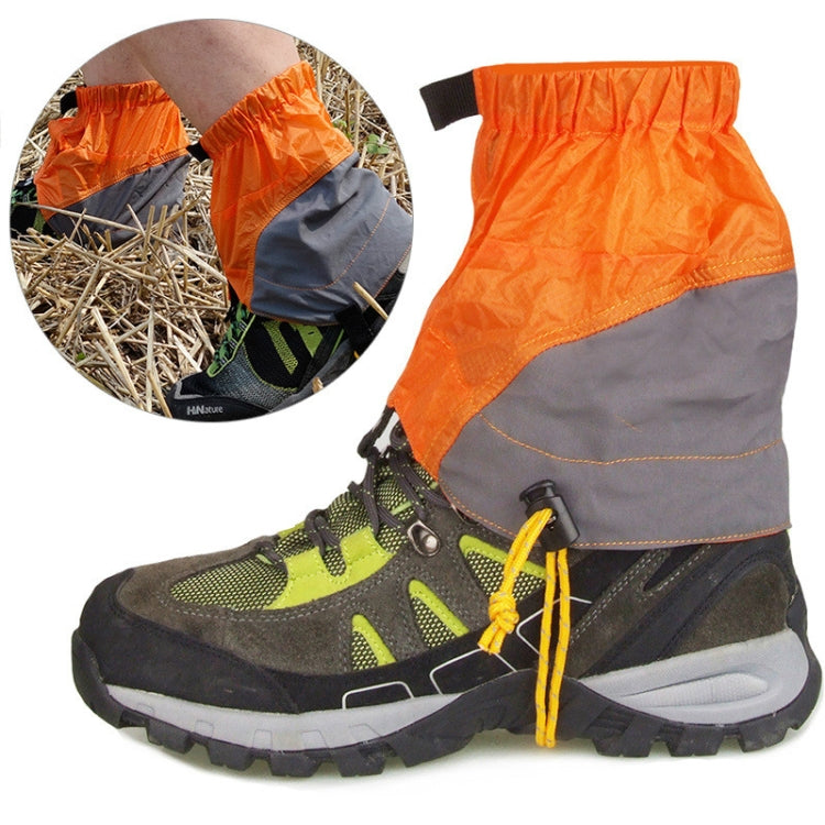 Orange outdoor waterproof legging covers over boots with elastic cuff and drawstring