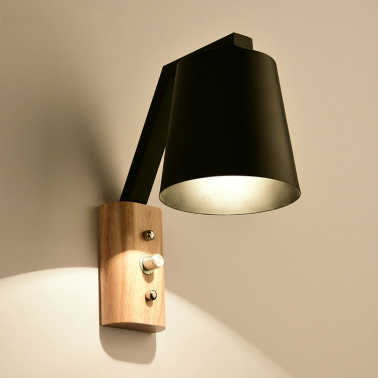 Wood wall sconce with black shade, adjustable arm, and built-in switch