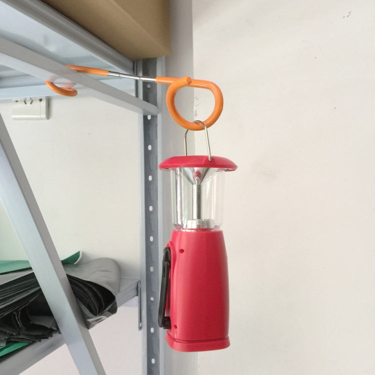 S-shaped metal hook with orange grips, hanging a red lantern from a bar.